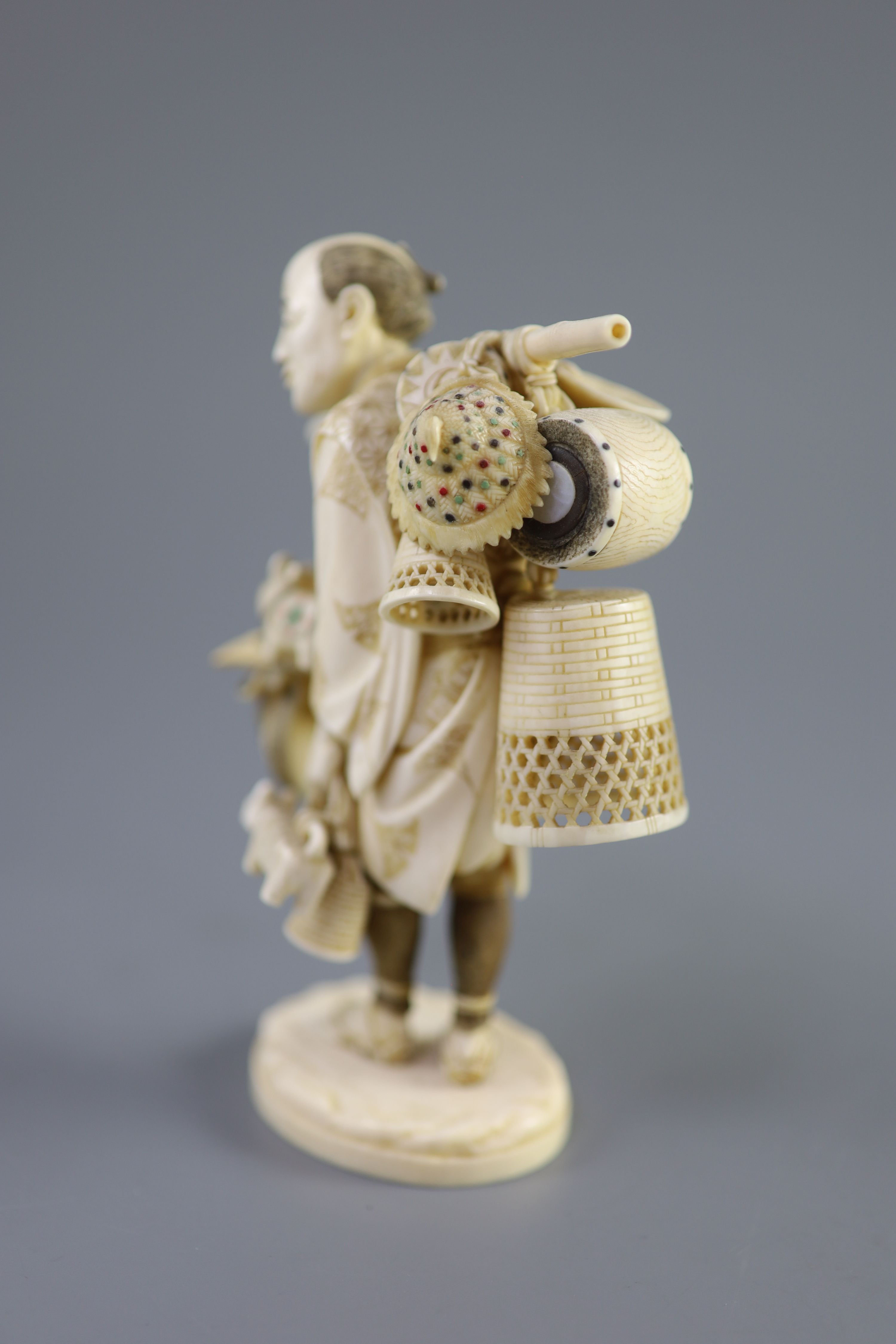 A Japanese ivory okimono of a basket seller, early 20th century 14.5 cm high